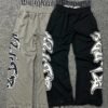 Layered Waist Graffiti Print Distressed Flared Sweatpants Layered Waist Graffiti Print Distressed Flared Sweatpants